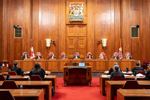 The judges and several lawyers sitting in the main courtroom